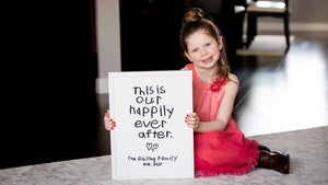 Little girl holding a custom made gift with her handwriting saying this is our happily ever after. From Inside Out creative studio offers laster cutting and custom etching with youths' handwriting. 